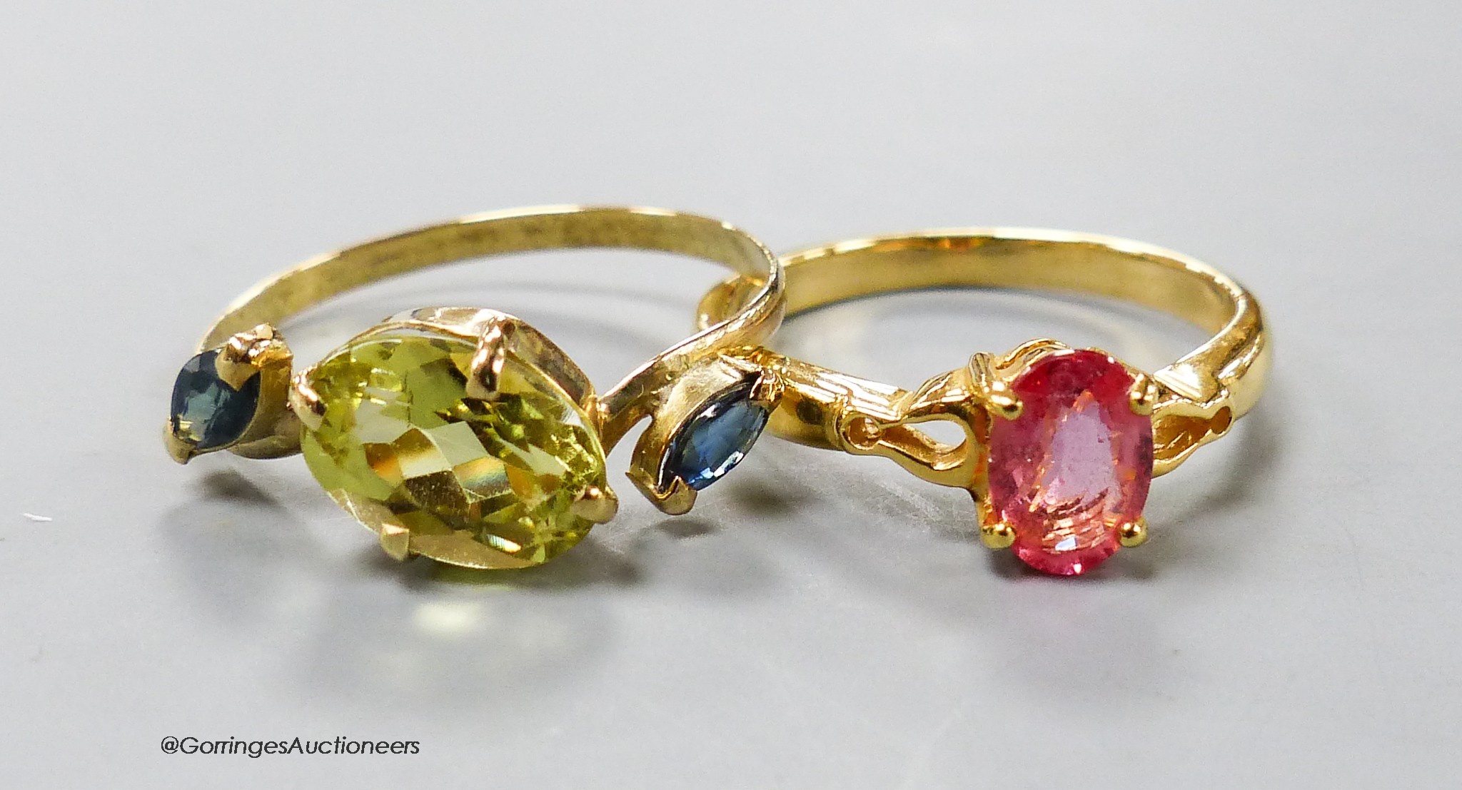A modern 18ct gold and gem set dress ring and a similar 18k ring, gross 4.4 grams.